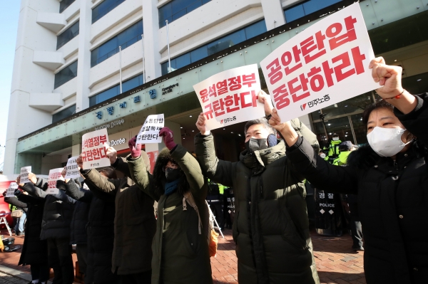 국정원이 민주노총에 대한 압수수색을 진행 중인 18일 오전 서울 중구 민주노총 앞에서 소속 조합원들이 피켓을 들고 규탄 구호를 외치고 있다.ⓒ뉴시스